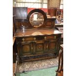 An early 20th century oak mirror back sideboard, arched gallery, circular bevel edge mirror,