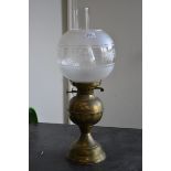 A Victorian oil lamp decorated with floral design