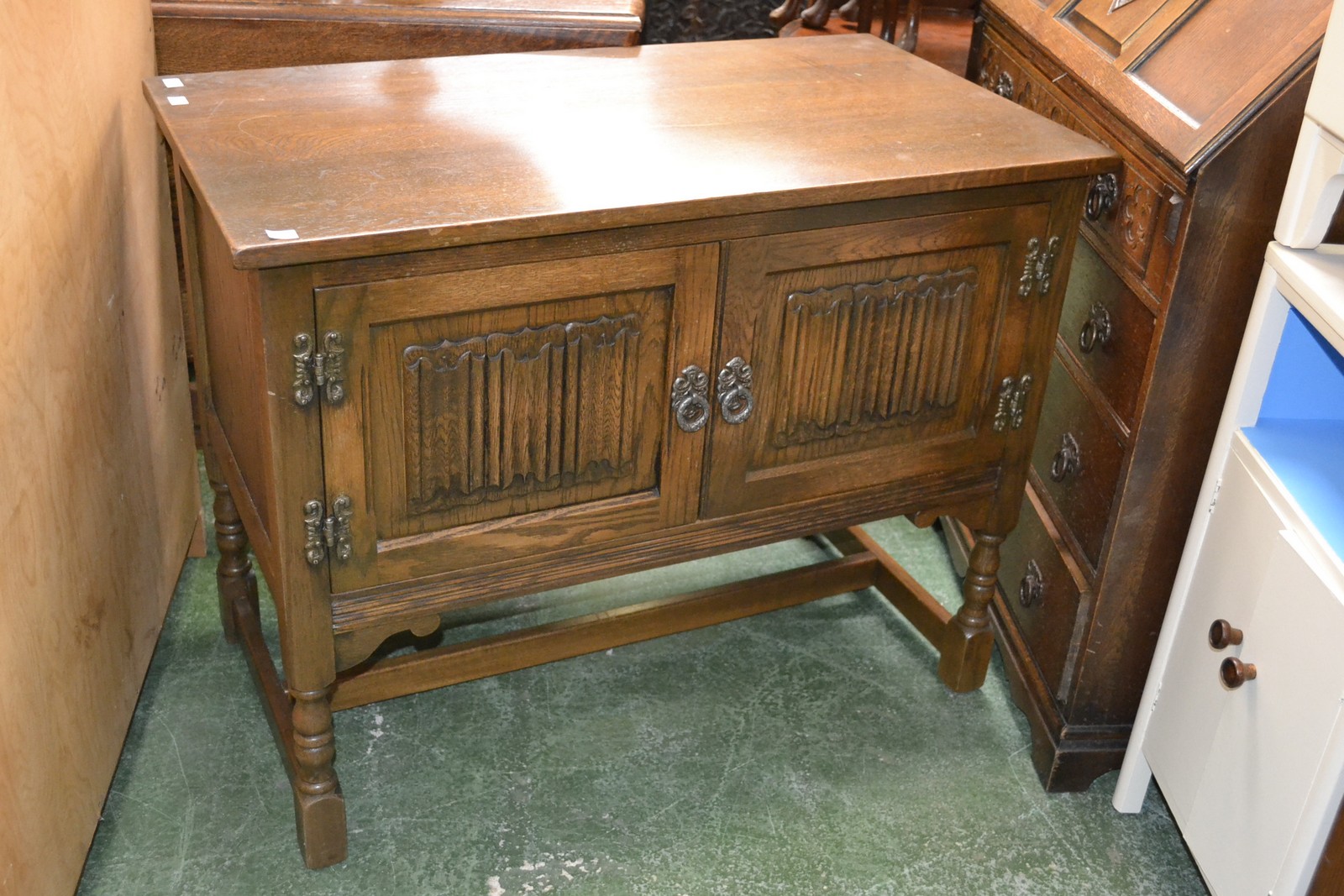 An Old Charm oak cabinet with linenfold doors.