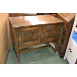 An Old Charm oak cabinet with linenfold doors.