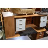 A retro office desk and a two door office cabinet.