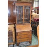 An Edwardian mahogany bureau bookcase of narrow proportions, glazed doors enclosing shelving to top,