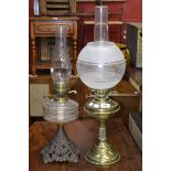 A Victorian cast iron oil lamp, clear glass reservoir; a brass oil lamp, twin burner,