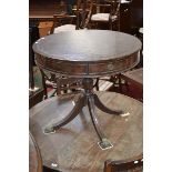 A Regency style mahogany drum table, leather inlaid top, baluster column, reeded sabre legs,