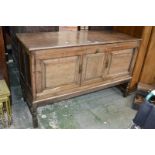 An oak sideboard, moulded top, two fielded panel doors, turned supports,