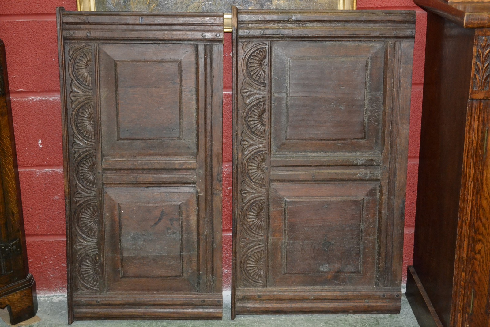 Two oak panels with carved lunette decoration over fielded panels.