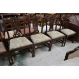 A set of four Chippendale Revival mahogany dining chairs,