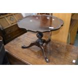 An oak tripod occasional table, piecrust circular top, fruitwood turned column, cabriole supports,