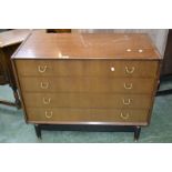 A G-Plan chest of four drawers raised on ebonised legs with suspension set plinth.