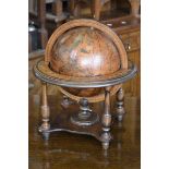 A wooden framed terrestrial globe