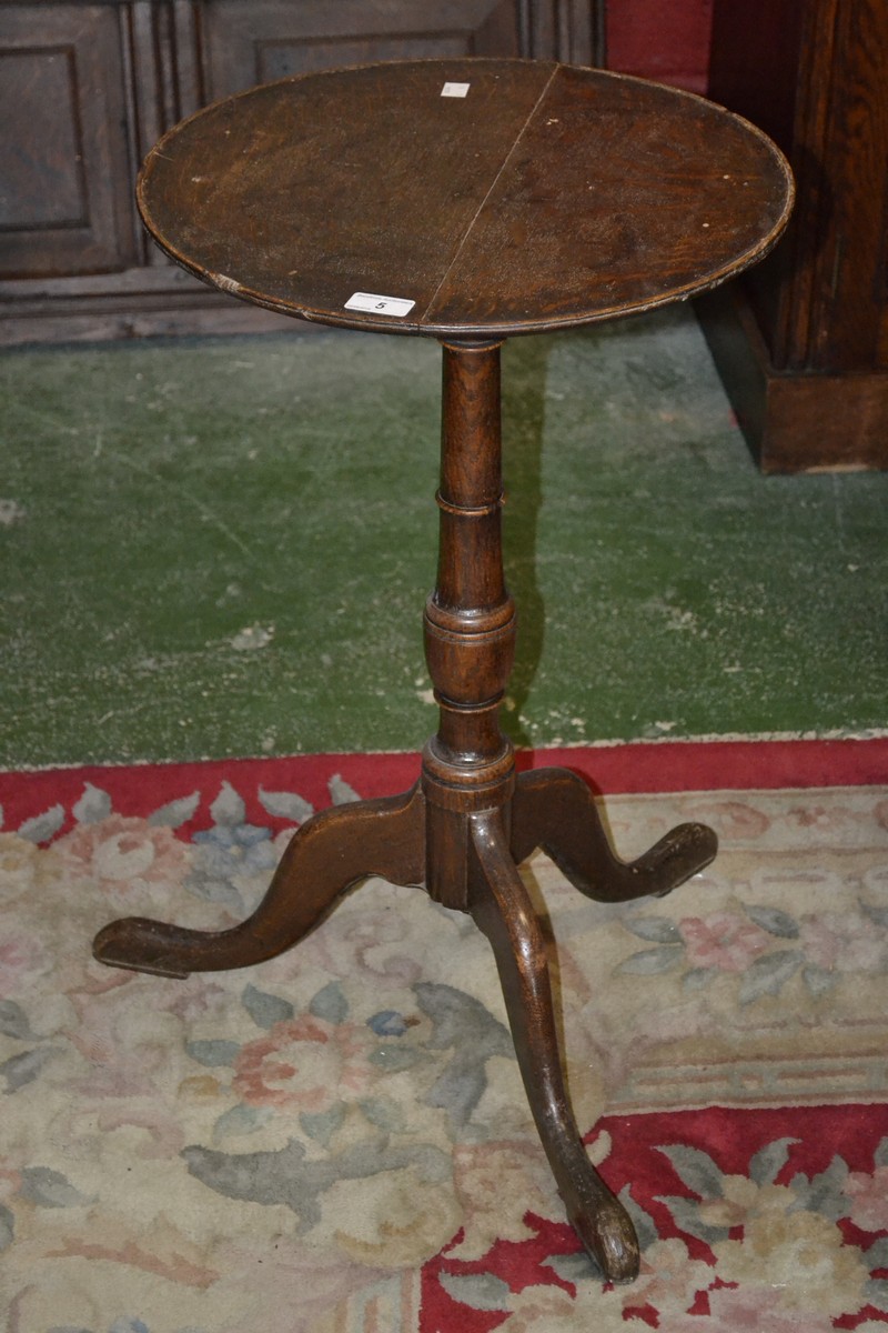 A George III oak tripod table, pad feet,