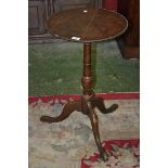 A George III oak tripod table, pad feet,