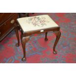 A reproduction tapestry top rectangular stool,