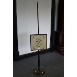 A Regency mahogany pole screen, square glazed screen with tapestry panel centre,