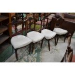 Four Victorian mahogany salon chairs, cresting top rail, pierced vascular splat, stuffed overseat,