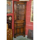A Titchmarsh and Goodwin oak floor standing corner cupboard,