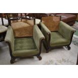 A pair of 19th century library chairs, cresting top rail, cane work back, padded scrolling arms,