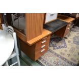 A contemporary office manager's desk, rectangular top with inlaid leather writing surface,