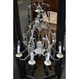 A glass and chromed metal five branch chandelier each branch bifurcating with faceted clear and