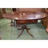 A reproduction dropleaf table, oval top, two drawers to frieze, turned column, four sabre legs,