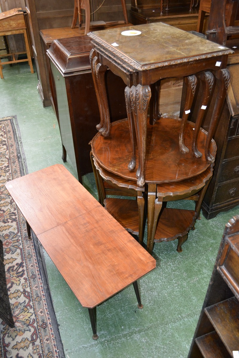 A mid 20th century nesto of three mahogany tables,