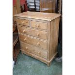A rustic pine chest of drawers