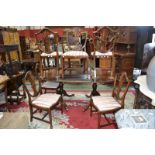 A reproduction mahogany twin pedestal dining table and eight shield back chairs,