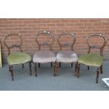 A set of four Victorian walnut balloon back chairs, horizontal shaped splat,
