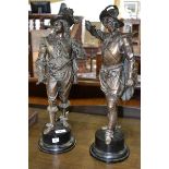 A pair of 17th century style 'bronzed' figures of royalist swordsmen