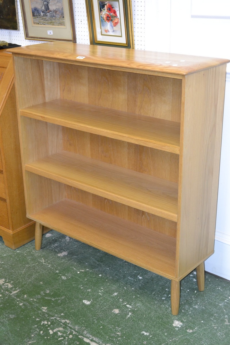 An Ercol style light oak three tier bookcase.