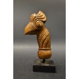 An Indonesian softwood kris handle, carved as a stylised bird, 11.
