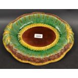 A Majolica oval dish decorated with wheat on a green ground