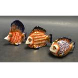 A set of three novelty hand painted fish models, hand decorated in the Imari palette, signed E.