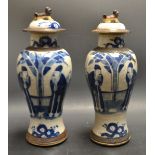 A pair of blue and white ginger jars with Dogs of Foe lids