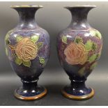 A pair of Royal Doulton tube lined vases, pink roses on a blue ground.