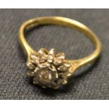 A diamond flower head cluster ring, central round brilliant cut diamond, approx 0.