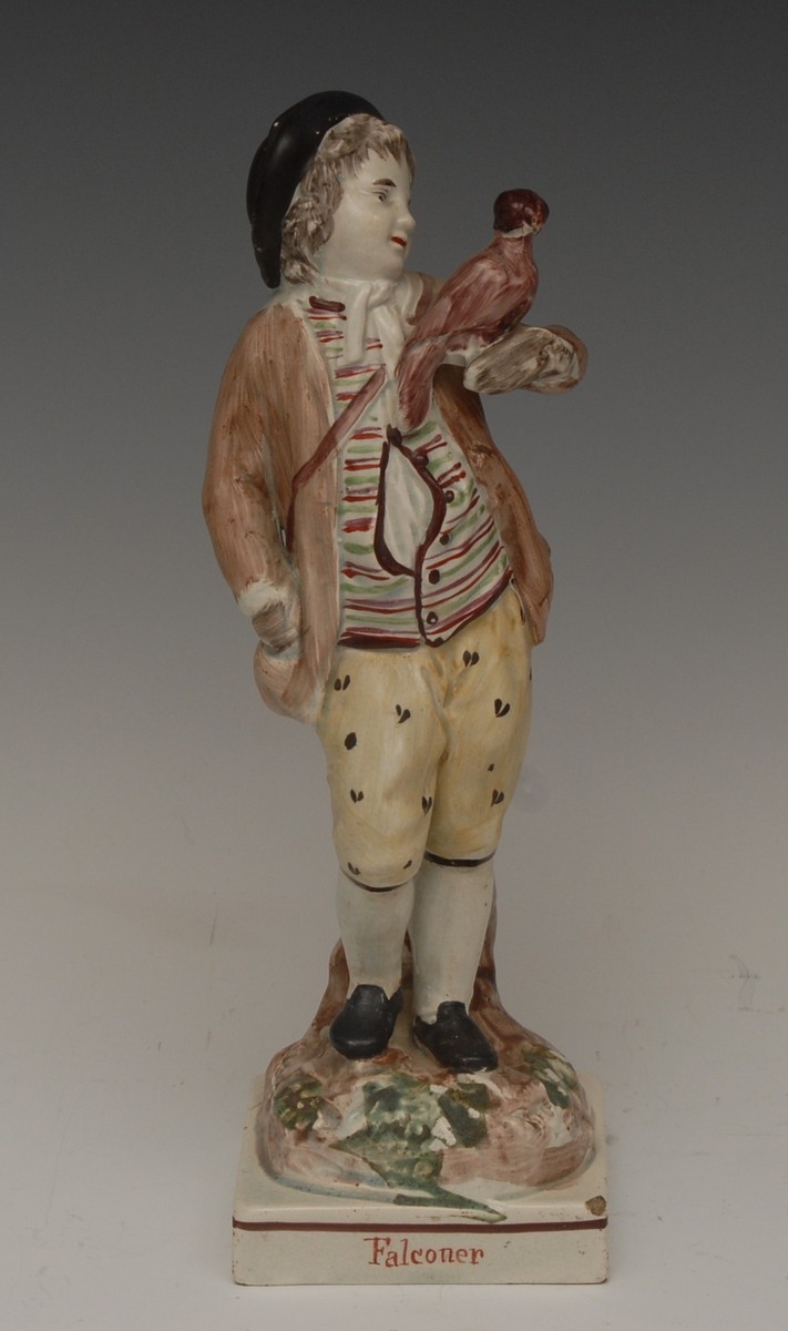 A Ralph Wood type Pearlware figure, The Falconer, he standing wearing a brown jacket,