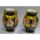 A pair of Royal Crown Derby 5704 pattern twin handled vases, printed marks,