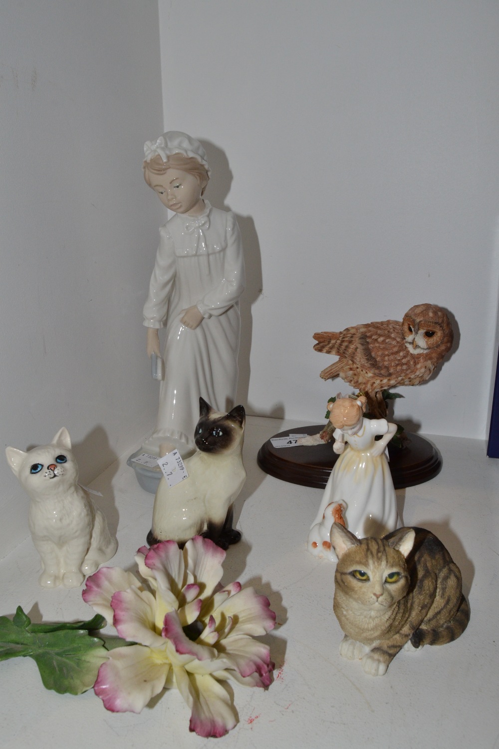 Decorative Ceramics - a Nao figure of a Girl; a Beswick model of a white cat; a Beswick Siamese cat;