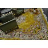 A large woolwork rug, cabbage roses and other flowers on a yellow ground,