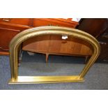 A contemporary gilt framed arched top overmantel mirror