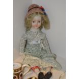 A composite doll, painted black shoes,