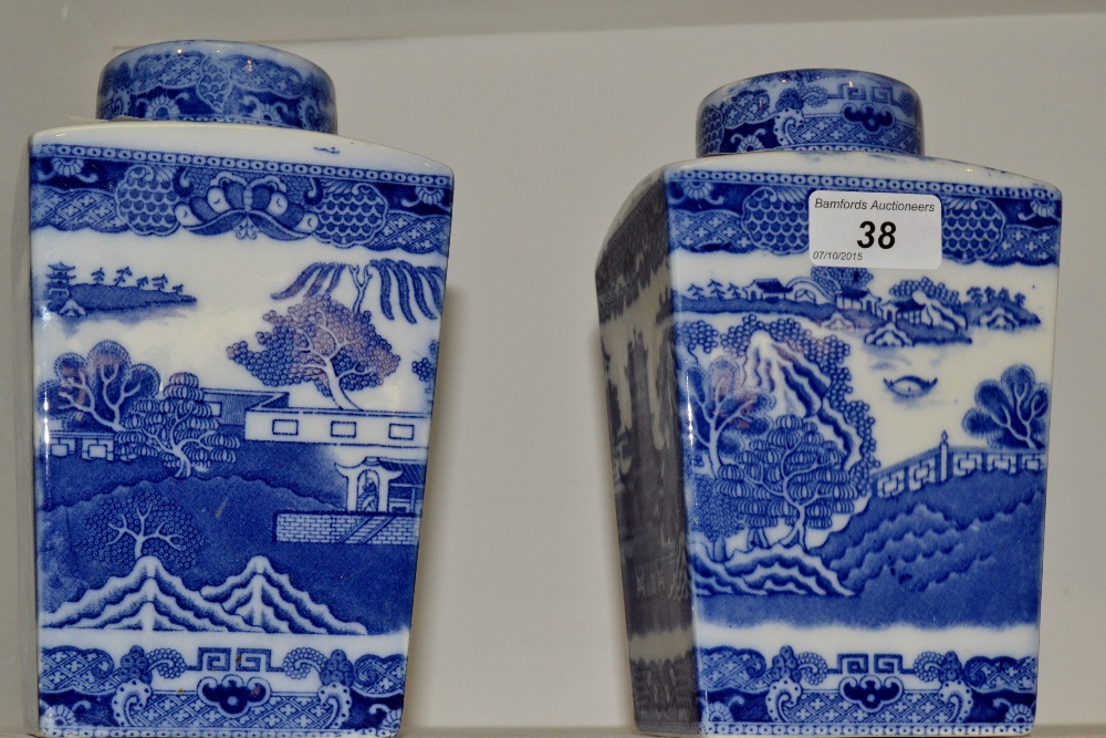 A pair of Ringtons tea caddy's printed with blue and white willow Pattern