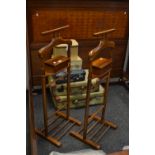 A pair of stained mahogany valet stands