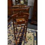 A pair of stained mahogany valet stands