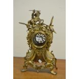 A Rococo style gilt metal clock case, of cartouche form, surmounted with an equestrian figure,