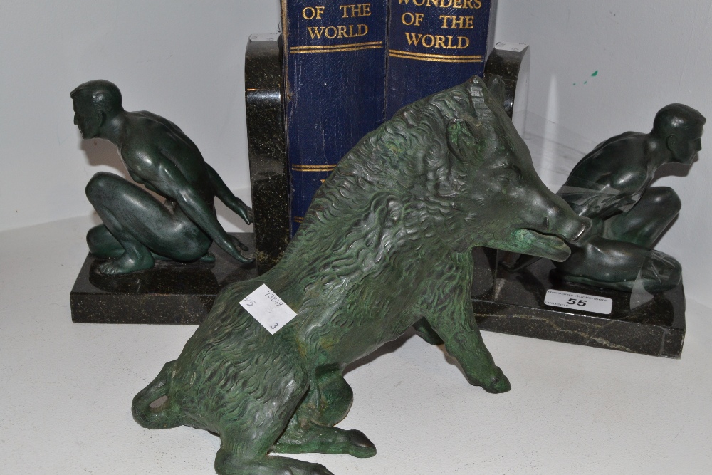 A pair of verdigris, bronzed and black marble bookends,