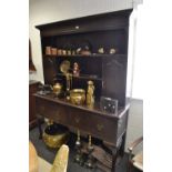 A George III style oak dresser, outswept cornice, two shelves and two cupboards to top,