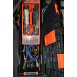 An orange and black plastic tool box containing tool bits;