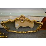 A large gilt shaped frame mirror,